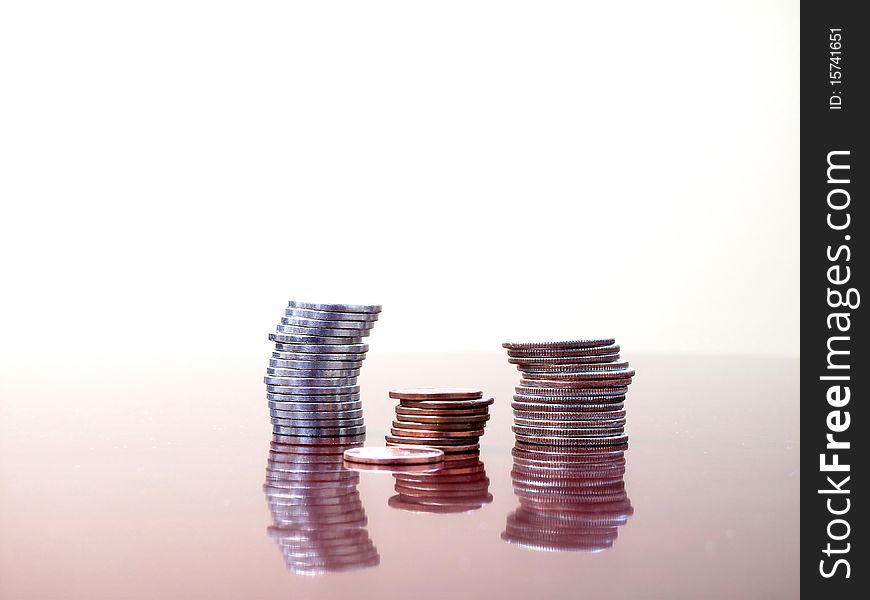 Stack of coins on desktop with white background