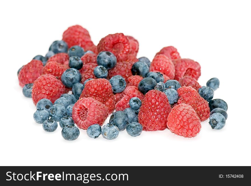 Fresh, juicy raspberries and blueberries isolated on white background. Fresh, juicy raspberries and blueberries isolated on white background.