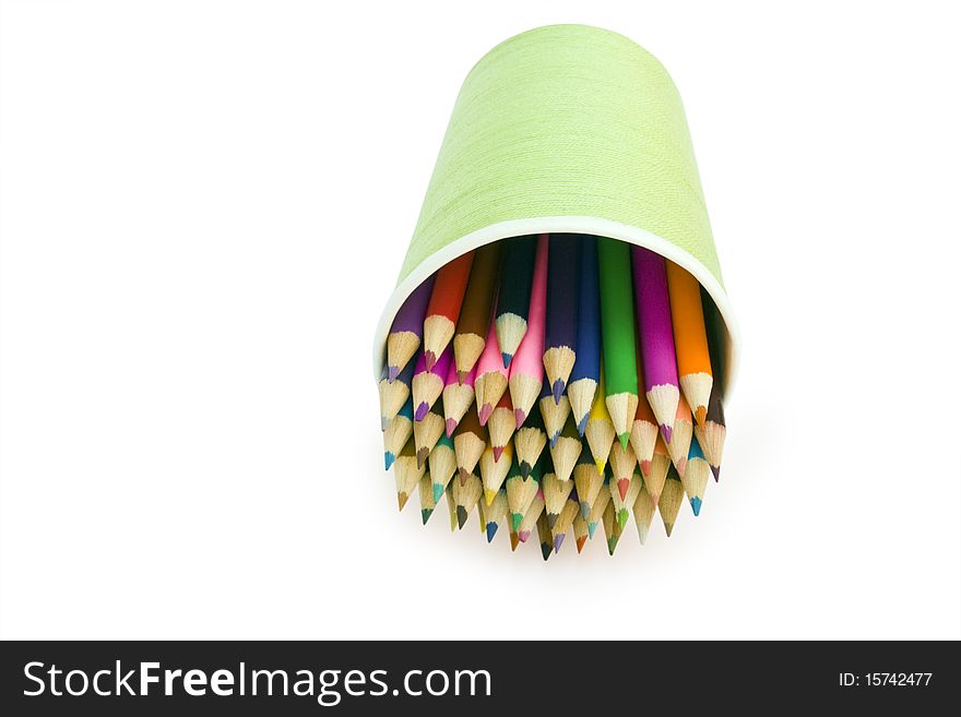 Isolated color pencils are in the glass on a white backround