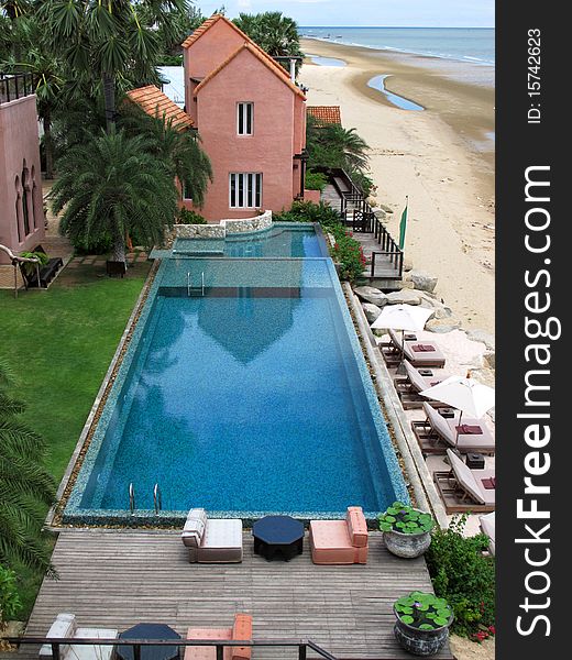 View of a hotel swimming pool near the beach from the top. View of a hotel swimming pool near the beach from the top