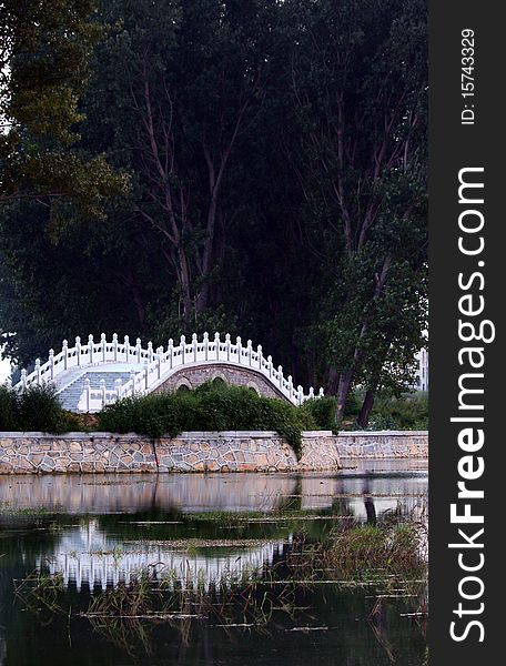 chinese-style stone bridge in the park. chinese-style stone bridge in the park.