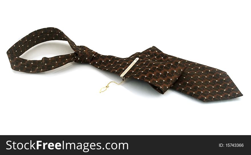 Tie with a gold pin on a white background