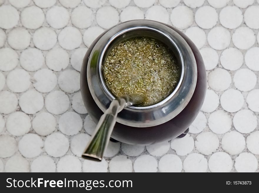 An Uruguayan mate gourd filled with yerba mate and ready to drink.