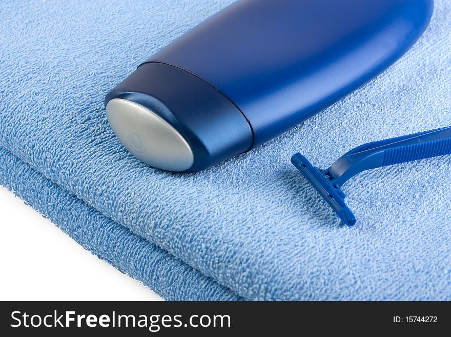 Shampoo And Razor On Blue Towel