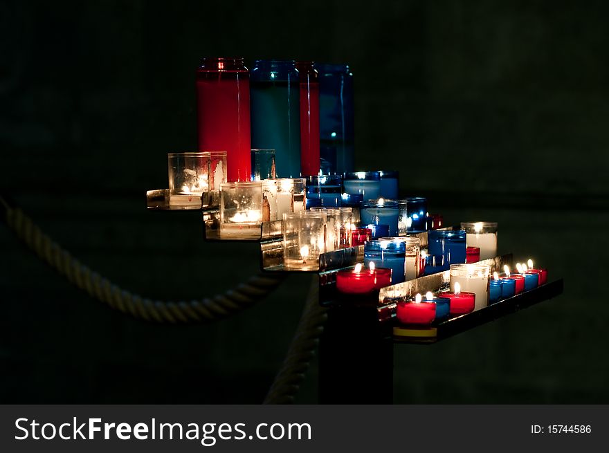 Red, blue and white prayer candles in a church in St. Malo, France