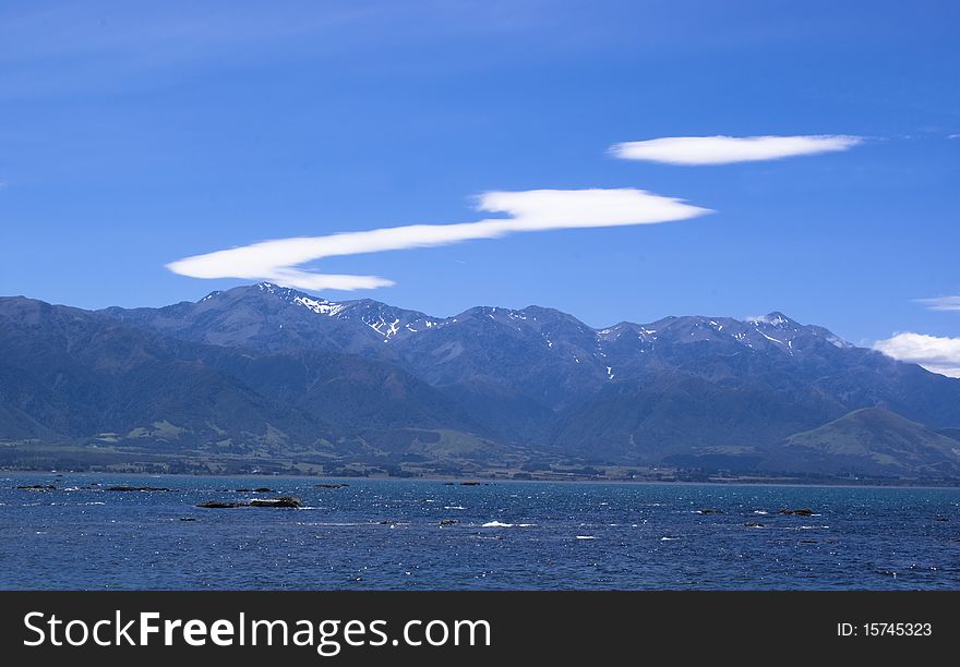 Mountain range with clouds forming an i. Mountain range with clouds forming an i