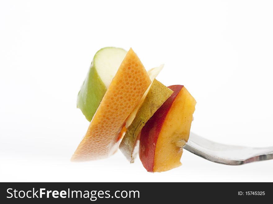 Fruit on a fork isolated on a white background
