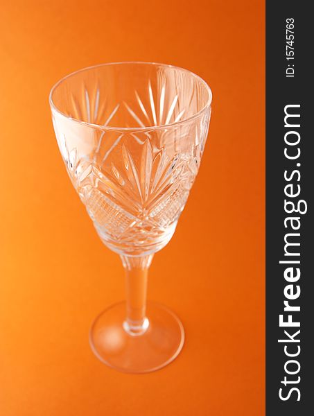 Transperent goblet on the orange background