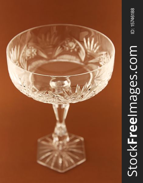 Wide goblet on the brown background