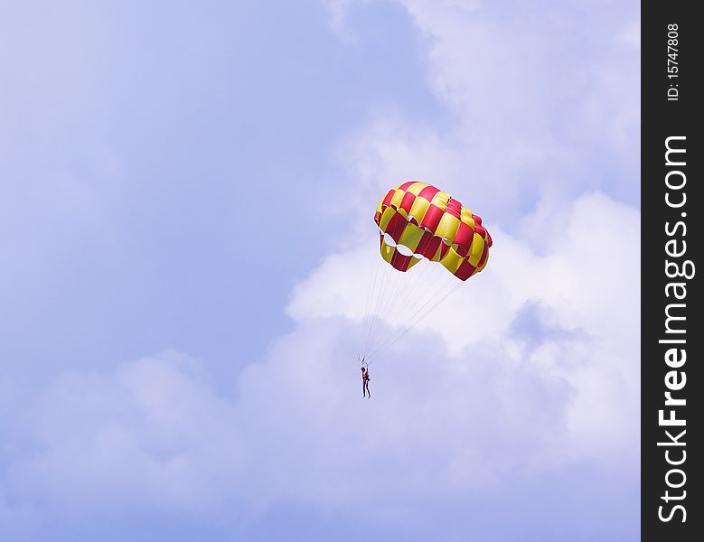 The image of parachutist under the sky