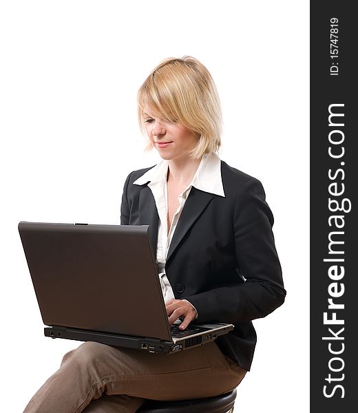 Young concentrated businesswoman typing on laptop. Young concentrated businesswoman typing on laptop