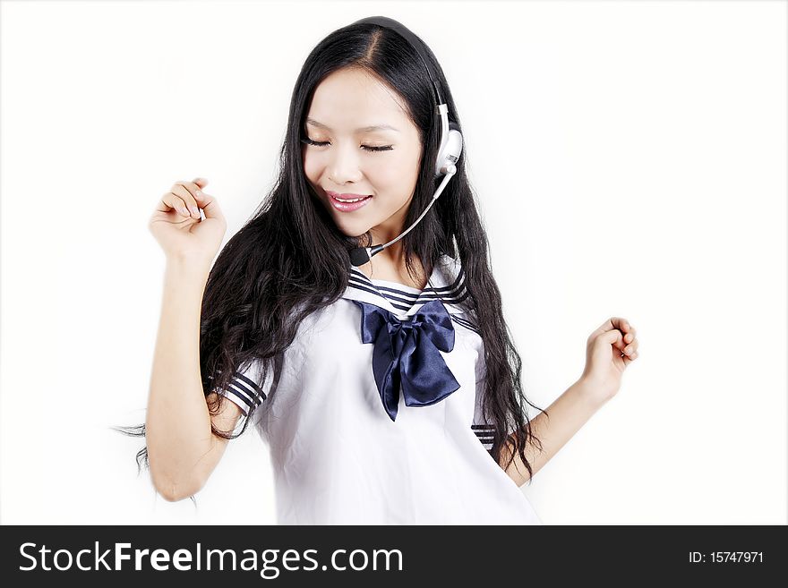 Asian schoolgirl in traditional uniform intoxicated by the music on white. Asian schoolgirl in traditional uniform intoxicated by the music on white.