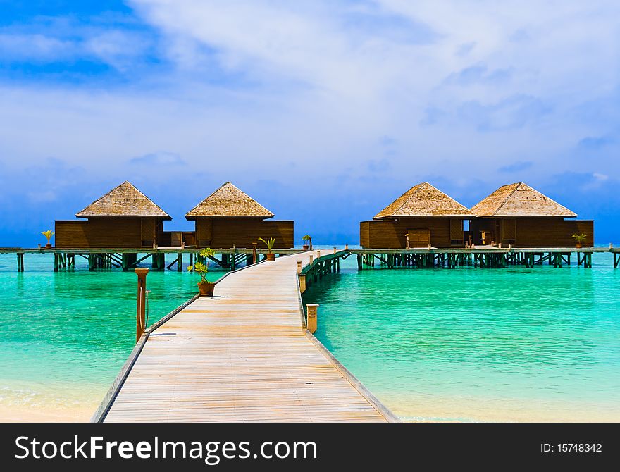 Water bungalows at a tropical island - travel background