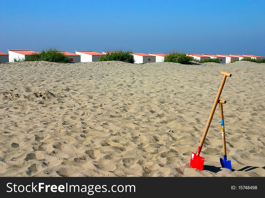 Beach cabins with child spades in the front. Beach cabins with child spades in the front