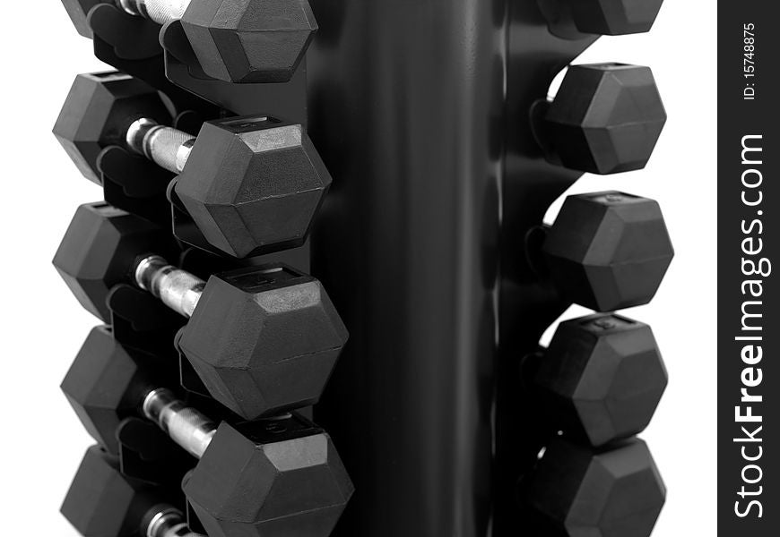 A dumbell rack with dumbells isolated against a white background