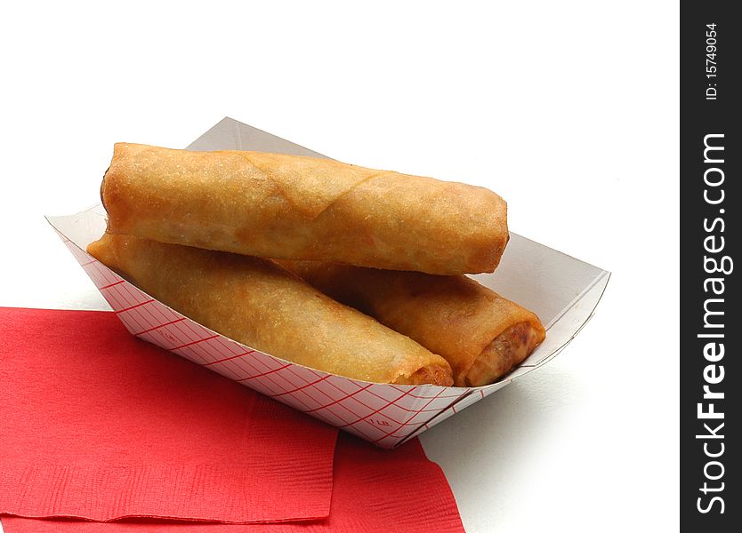 Three eggrolls on red napkin 
on white background