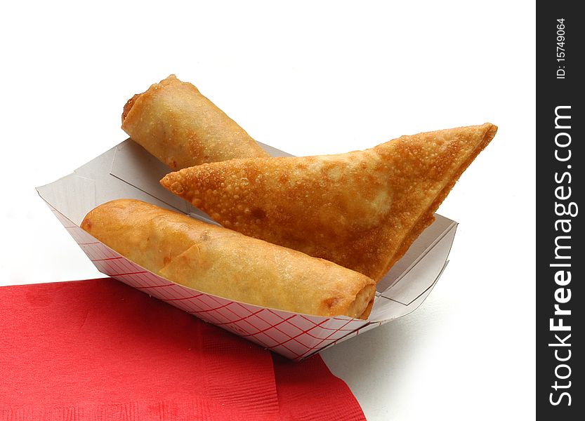 Two eggrolls and a wonton 
on red napkin 
on white background