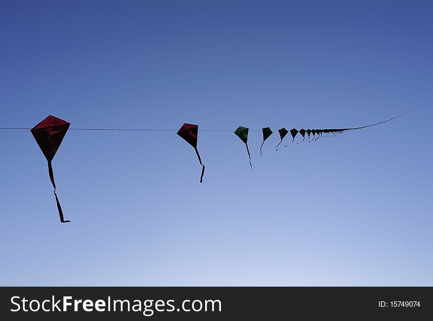 A row of kite in the blue sky