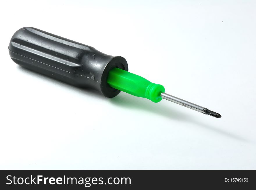 A green screwdriver on background