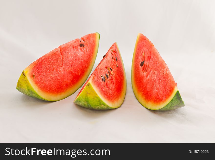 A row of sliced seedless watermelon. A row of sliced seedless watermelon.