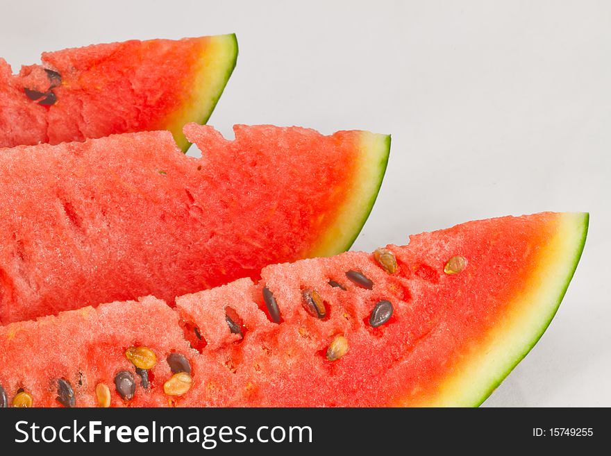 A row of sliced seedless watermelon. A row of sliced seedless watermelon.