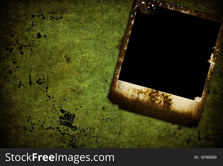 A isolated grunge burned photo on a green wall. A isolated grunge burned photo on a green wall