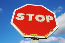 Old Red STOP Sign Over Blue Sky Background Stock Photo Old Red STOP Sign Over Blue Sky Background Stock Photo