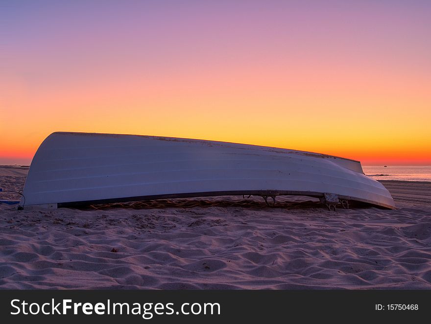 Lifeguard boat on sandy beach at dawn