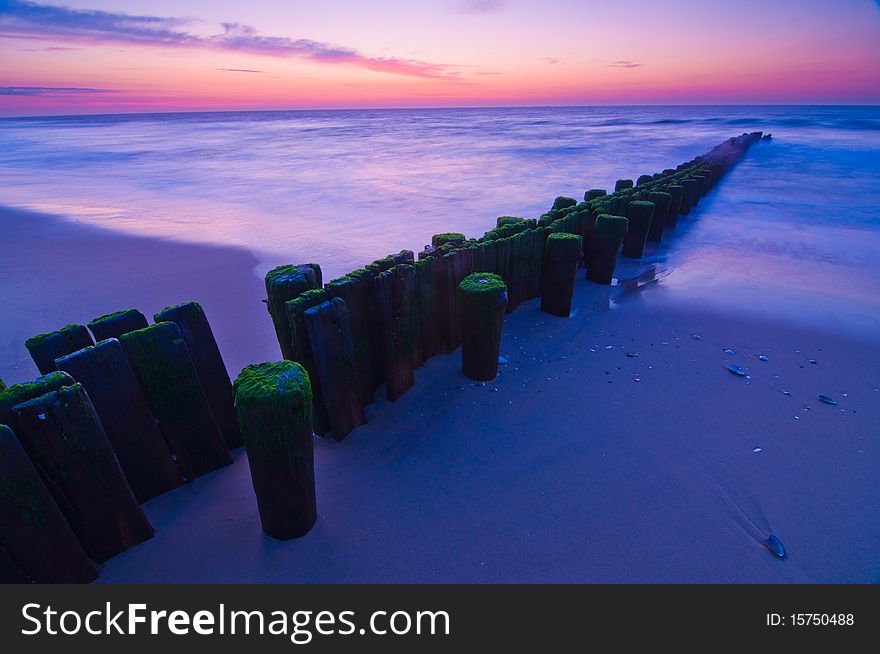 Pilings going into ocean at dawn. Pilings going into ocean at dawn