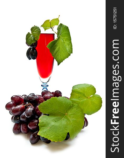 Red wine in glass with plump grapes. Isolated on white. Soft shadow. Red wine in glass with plump grapes. Isolated on white. Soft shadow