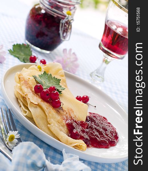 Pancakes with red currant jam for breakfast. Pancakes with red currant jam for breakfast