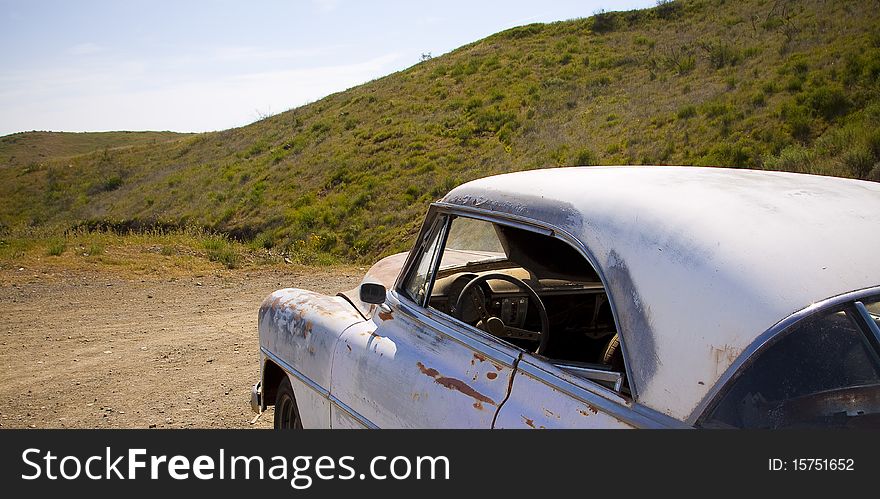 An old car left in the desert.