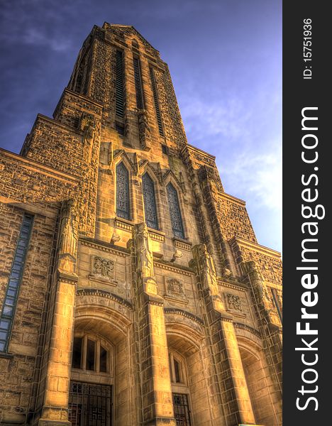 This is an HDR image of a stone church, with statues of four saints. The view is only of the front, high rising steeple, taken during the evening sunset which gives it the stone a warm glow. This is an HDR image of a stone church, with statues of four saints. The view is only of the front, high rising steeple, taken during the evening sunset which gives it the stone a warm glow.