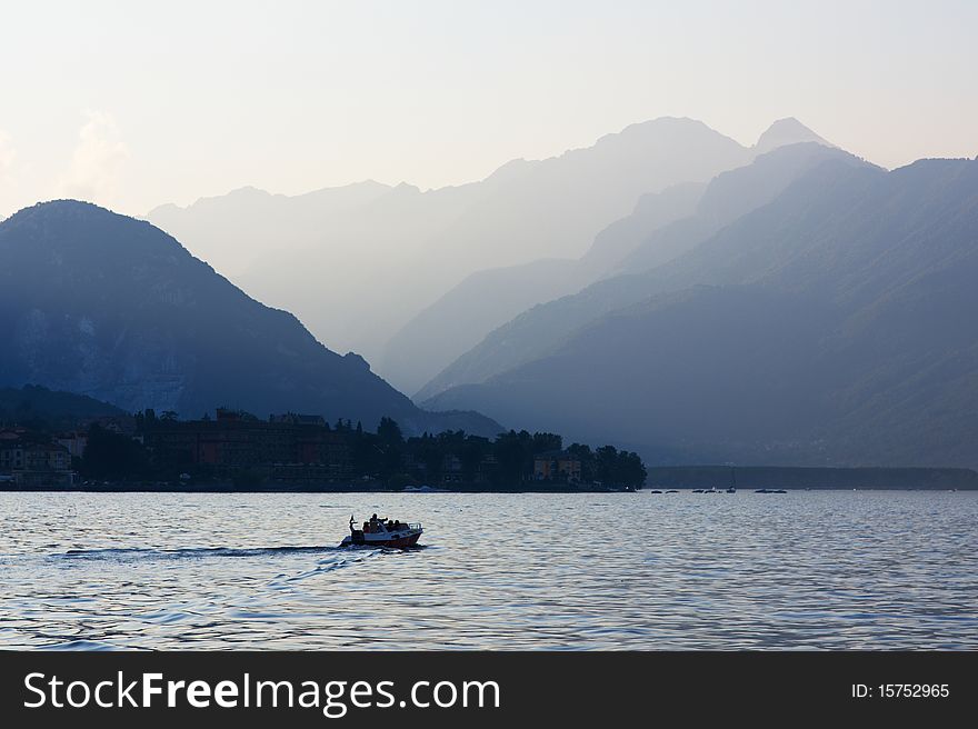 Sunset in mountains of Lake Maggiore (Lago Maggiore), with a motor boat, Italy, Aug 2010