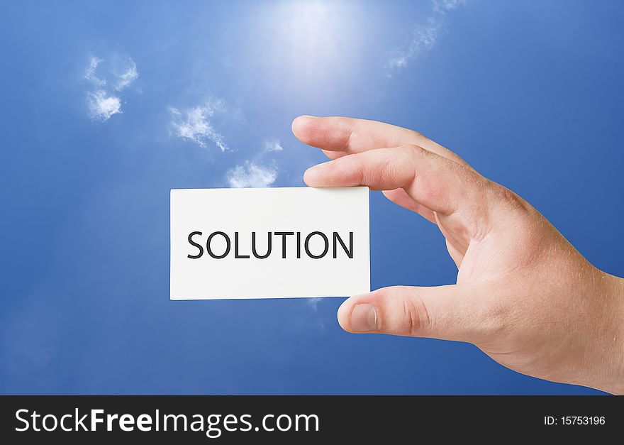 Solution text on white card in human hand