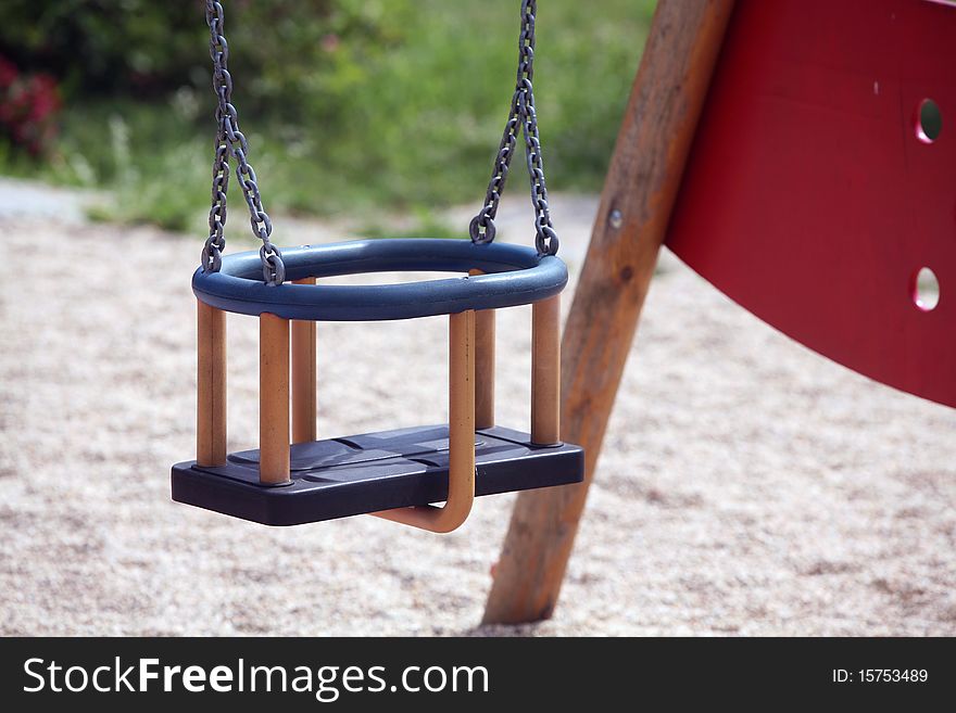 Detail of empty swing on playground