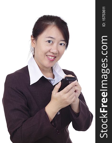 An Asian businesswoman texting on a smartphone with a stylus. An Asian businesswoman texting on a smartphone with a stylus.