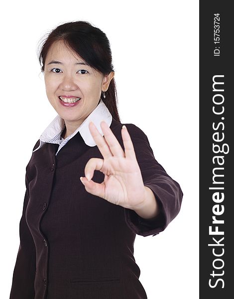 An Asian businesswoman giving the OK sign. An Asian businesswoman giving the OK sign.