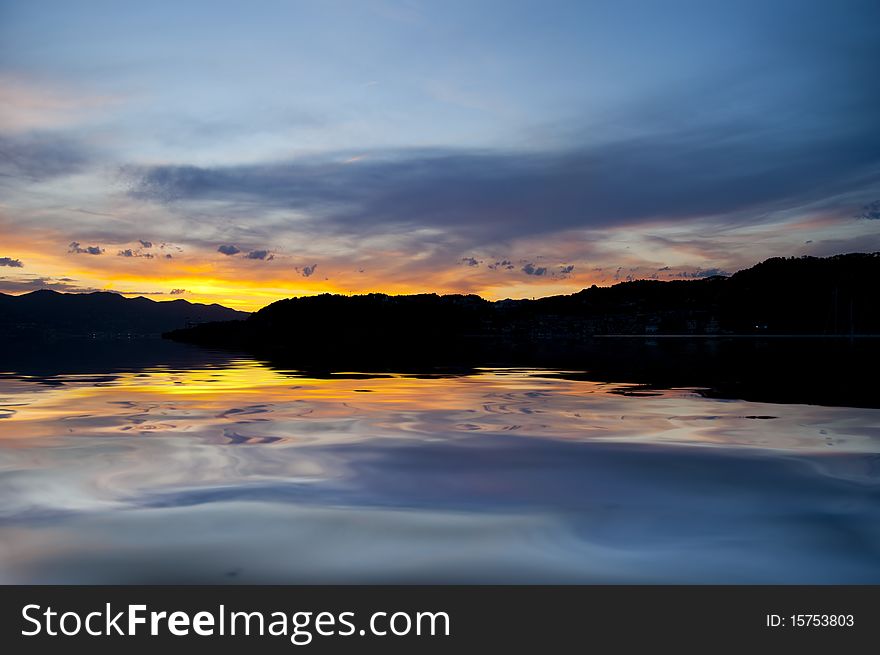 A yellow sunset over the calm sea