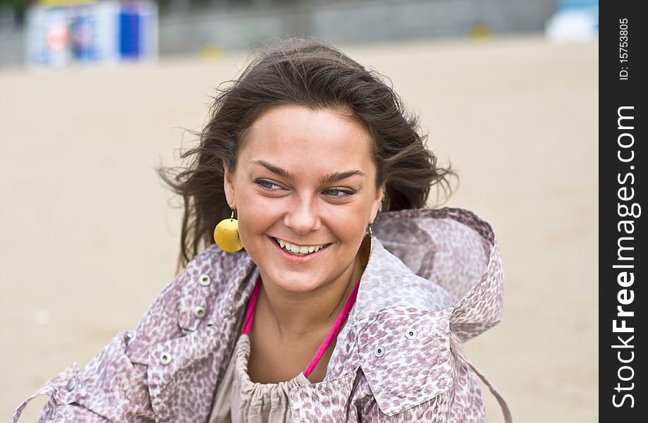 Cute attractive women smiling at the beach. Summer portrait. Blurring background.