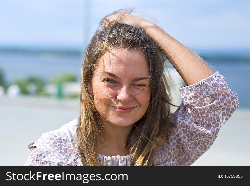 Cute attractive women smiling at the beach. Summer portrait. Blurring background.