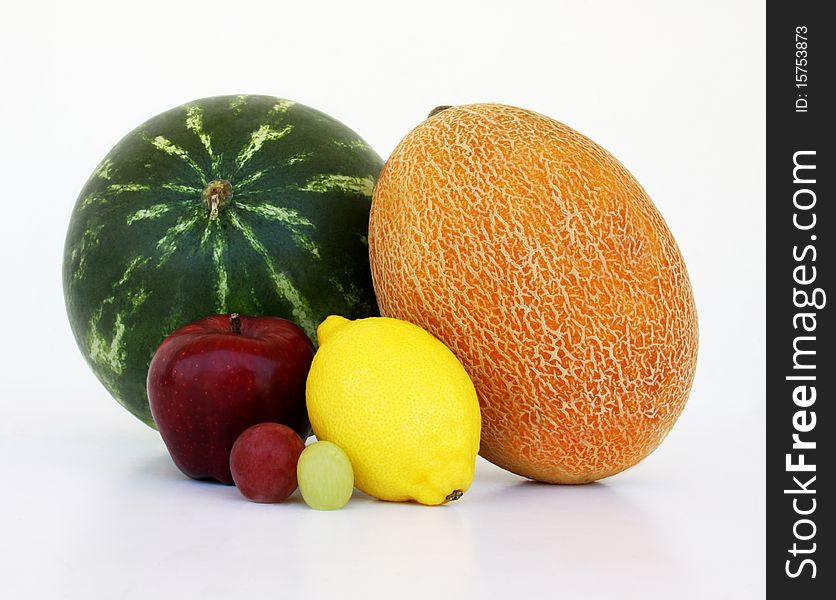 Watermelon, yellow melon, apple, lemon, and grapes looking like couples isolated on white background. Watermelon, yellow melon, apple, lemon, and grapes looking like couples isolated on white background