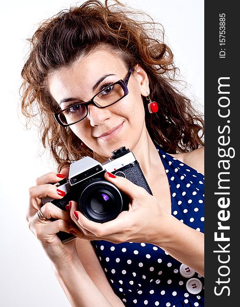 Beautiful woman in a blue polka dot dress with camera