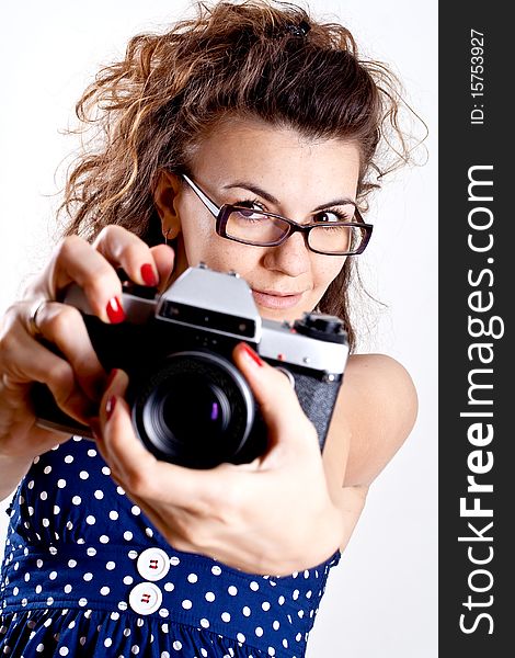 Beautiful woman in a blue polka dot dress with camera