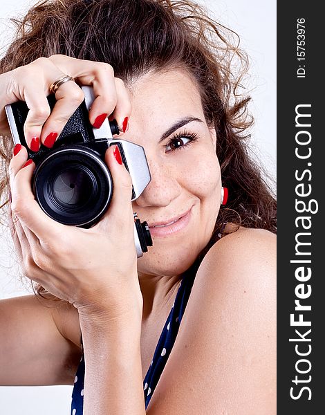 Beautiful woman in a blue polka dot dress with camera