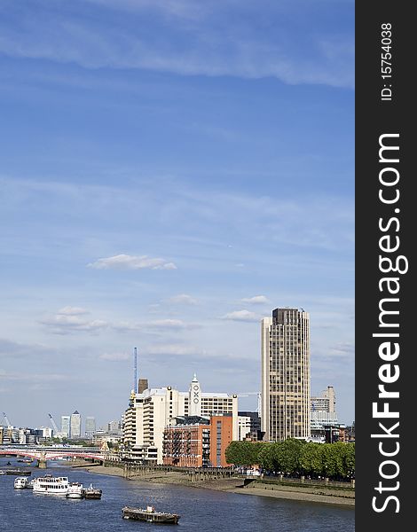 Boats crossing thames river and modern constructions against blue sky in london uk europe. Boats crossing thames river and modern constructions against blue sky in london uk europe