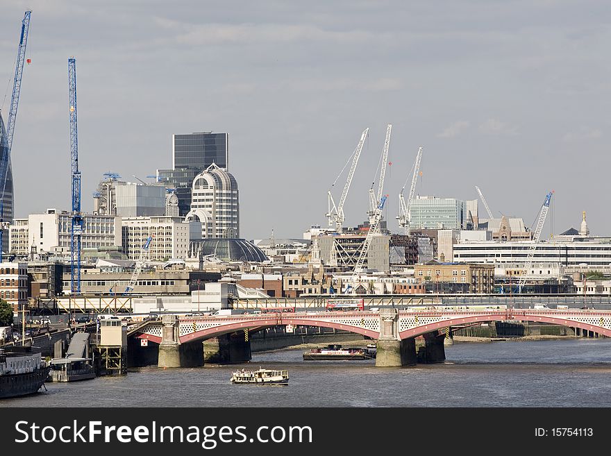 Boats crossing thames river and modern constructions against blue sky in london uk europe. Boats crossing thames river and modern constructions against blue sky in london uk europe