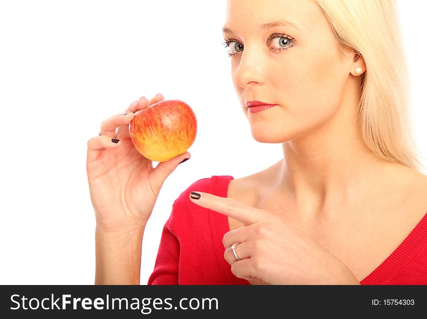 Young blond woman showing a apple. Young blond woman showing a apple