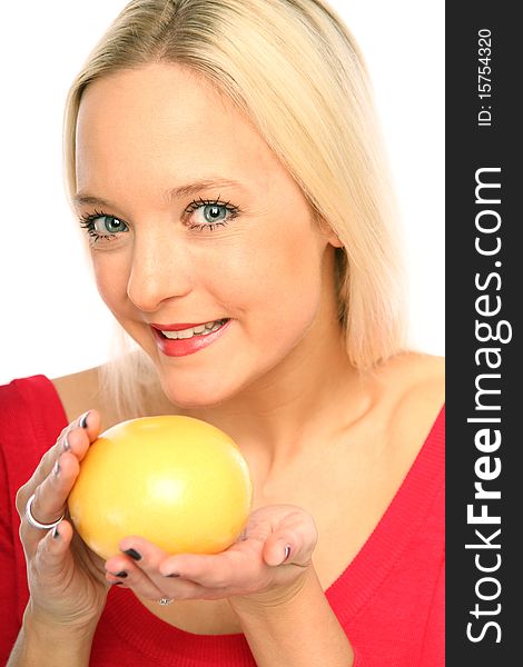 Young blond woman showing a grapefruit. Young blond woman showing a grapefruit