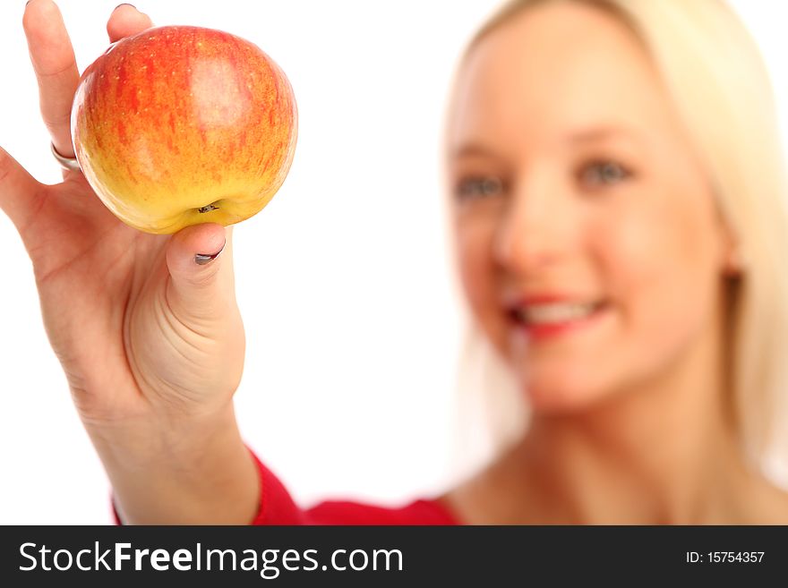 Young blond woman showing a apple. Young blond woman showing a apple